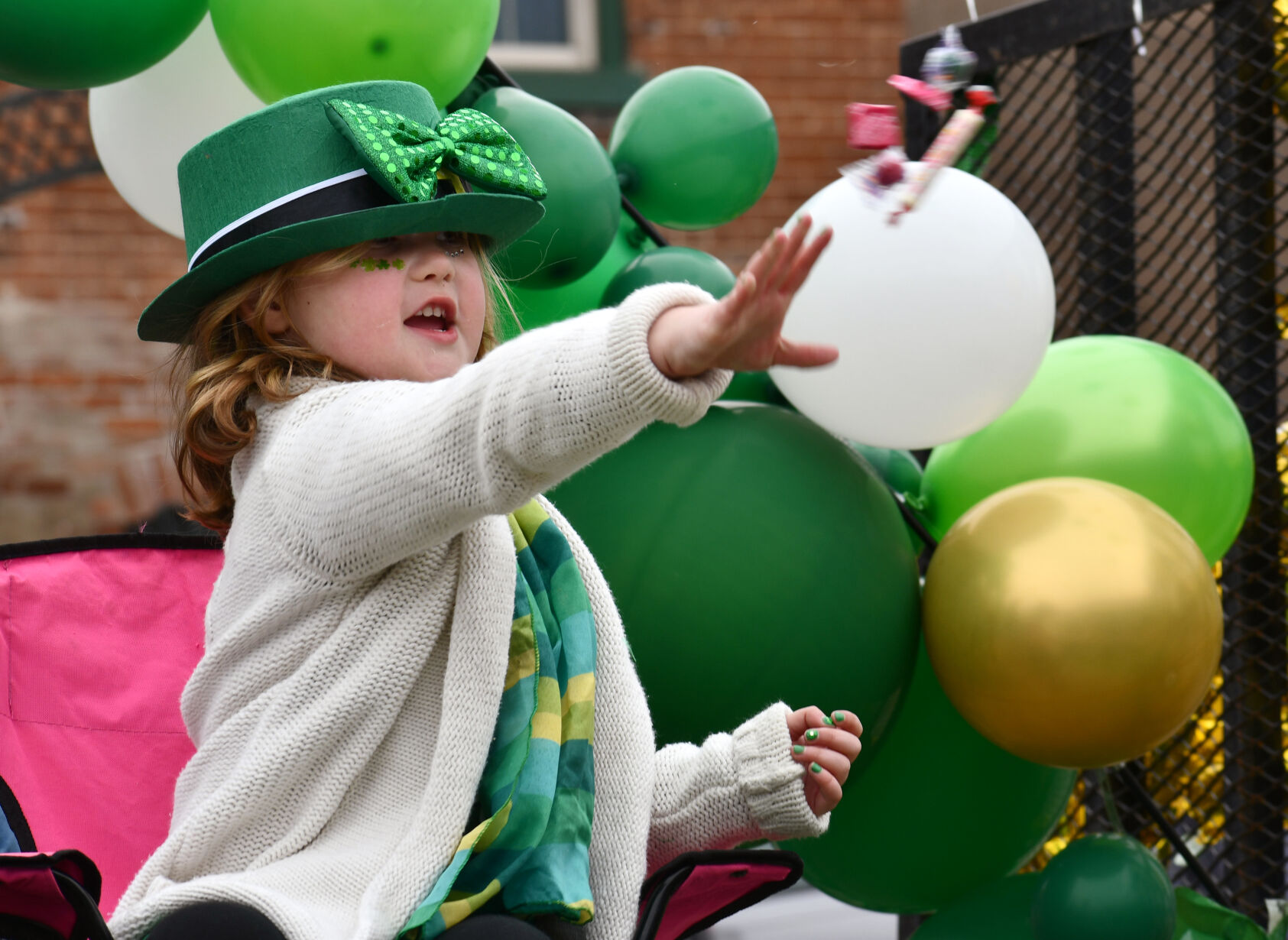 A girl tosses candy from a float
